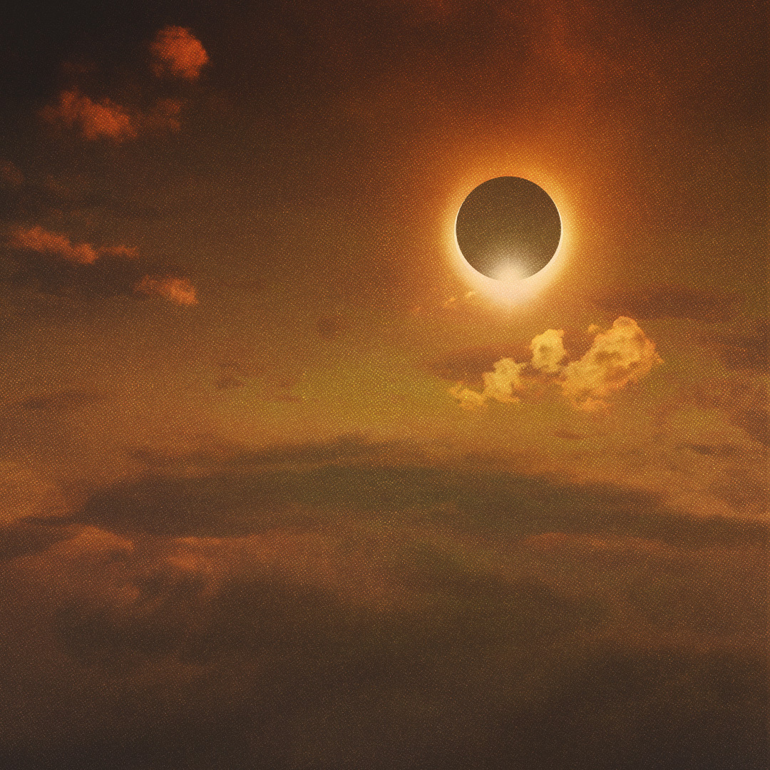 Éclipse solaire totale dans un ciel brillant rouge foncé.