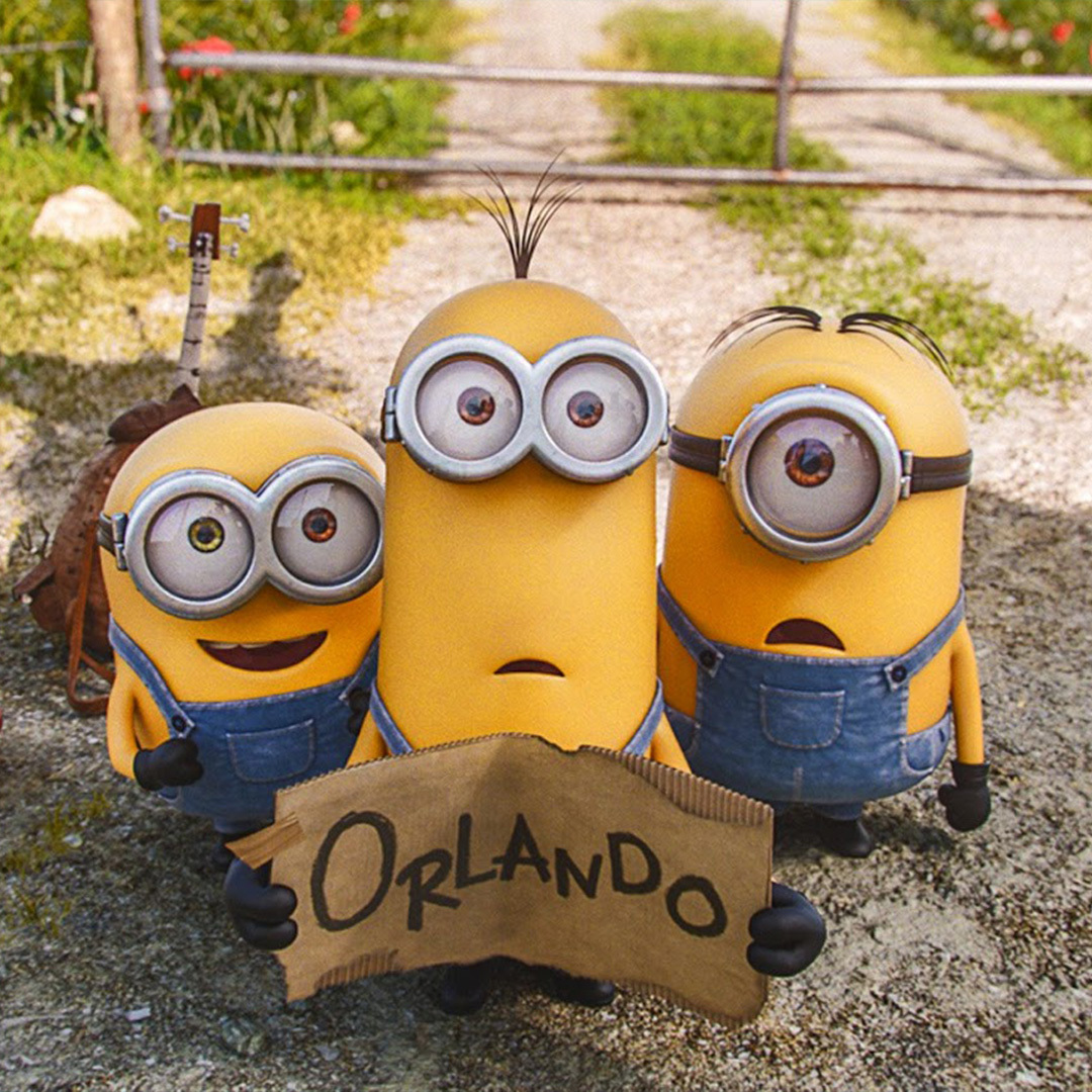 Les Minions en bodure de route avec une affiche pour Orlando en mains.