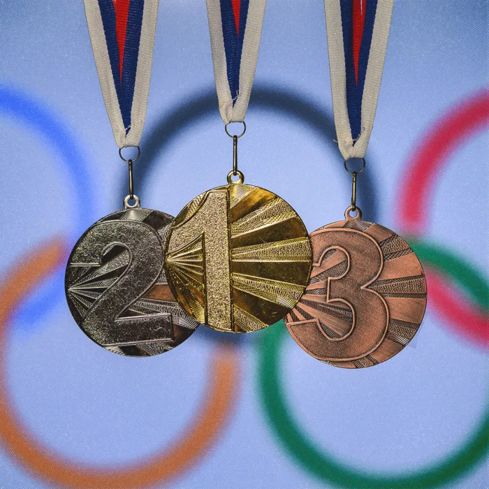 Médailles olympiques, or, argent et bronze sur fond des anneaux olympiques.