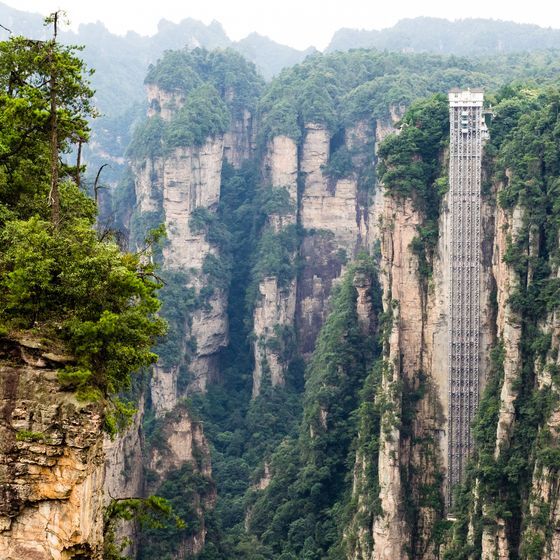 China is home to the world’s tallest outdoor lift, which is built among stone pillars in a forest.
