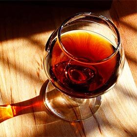 Alcohol (70% or 90%) is added to a fermenting wine to create port.