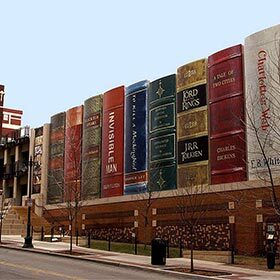 The Community Bookshelf wall of books hides a municipal parking lot.